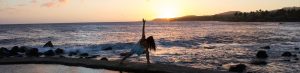 A lady doing yoga on a beach