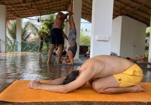 A group of people doing Yoga at India Yoga School.