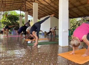 A group of people doing Yoga at India Yoga School.